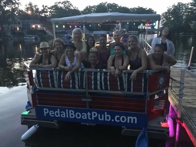 A girls' night group at the back of the boat at twilight