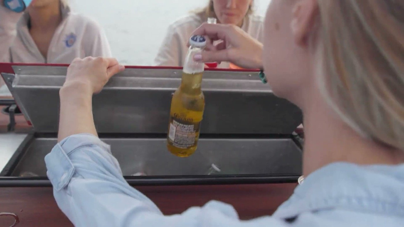A guest reaching into the iced trough cooler on the bar