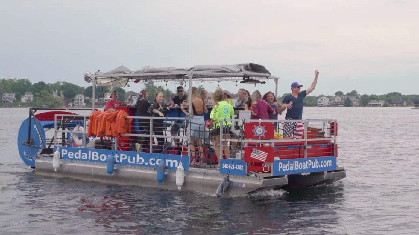 The Pedal Boat Pub leaving the dock with a full boat waving